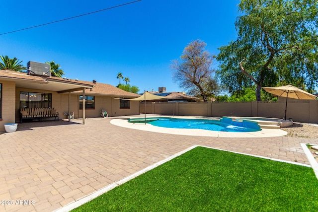view of pool featuring a lawn, central AC, a patio, and a fenced backyard