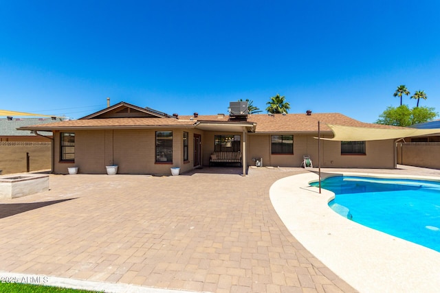 view of swimming pool with fence, cooling unit, a patio area, and a fenced in pool