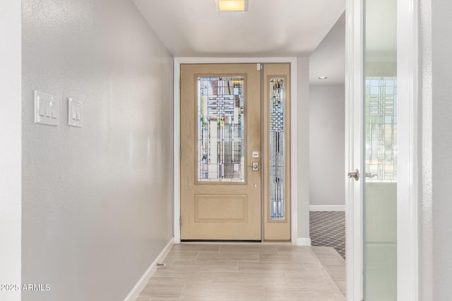foyer featuring baseboards