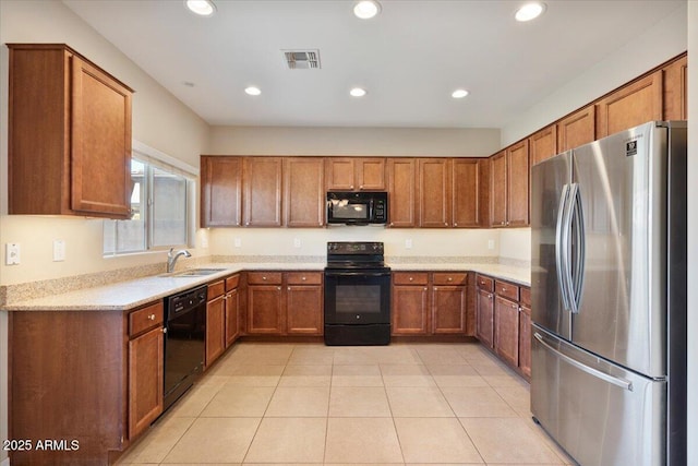 kitchen featuring light tile patterned floors, sink, and black appliances