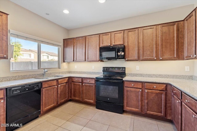 kitchen featuring sink, light tile patterned floors, and black appliances