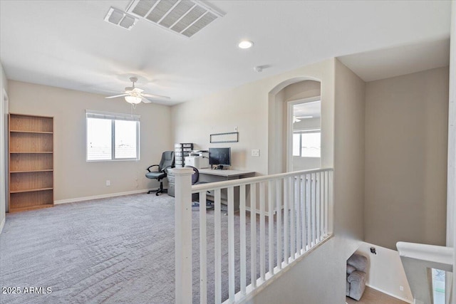 carpeted office featuring ceiling fan