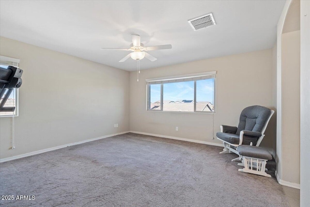 sitting room with ceiling fan and carpet floors