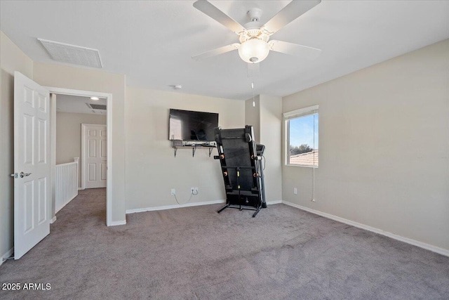 workout area featuring light colored carpet and ceiling fan