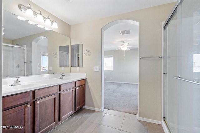 bathroom featuring walk in shower, ceiling fan, vanity, and tile patterned flooring