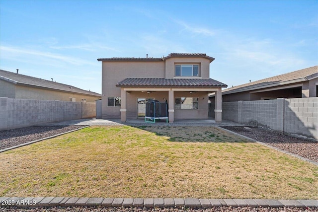 rear view of property with a lawn and a patio