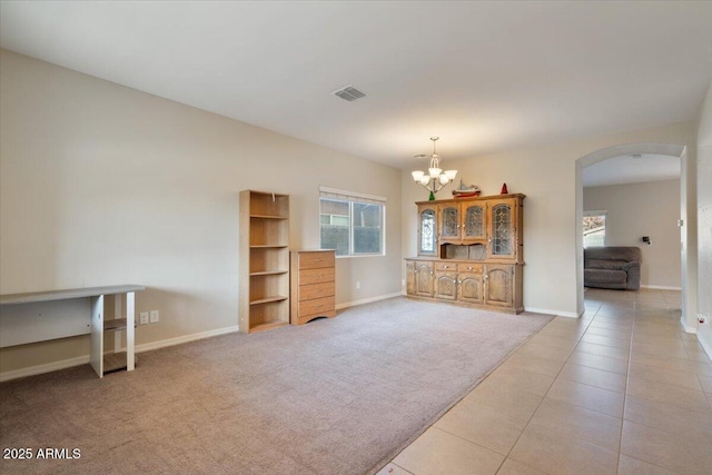 living room with light colored carpet and a chandelier