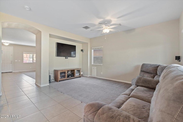 carpeted living room featuring ceiling fan