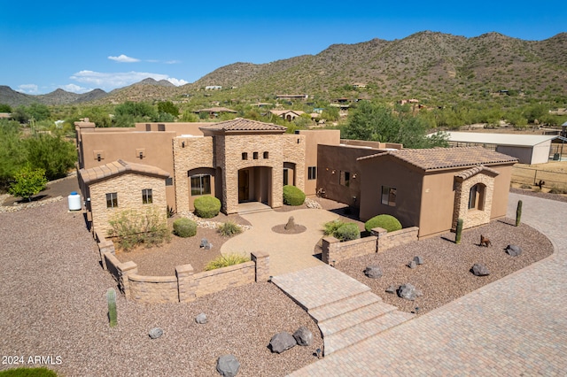 view of front facade with a mountain view and a patio