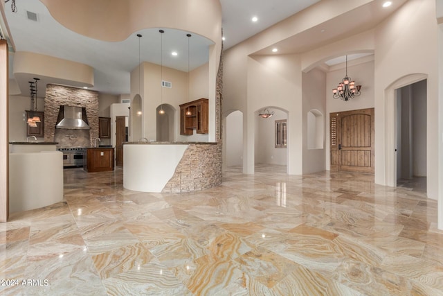 3730 E Cloud Rd, Cave Creek, AZ 85331 - interior space featuring visible vents, marble finish floor, arched walkways, a high ceiling, and an inviting chandelier
