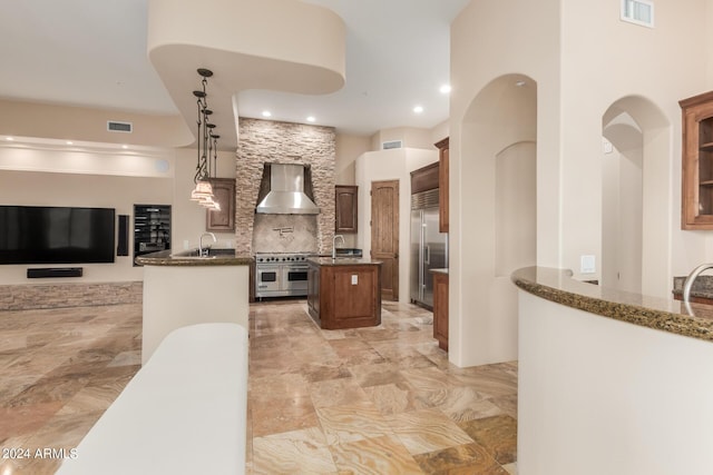 3730 E Cloud Rd, Cave Creek, AZ 85331 - kitchen featuring high end appliances, wall chimney exhaust hood, a center island with sink, open floor plan, and visible vents