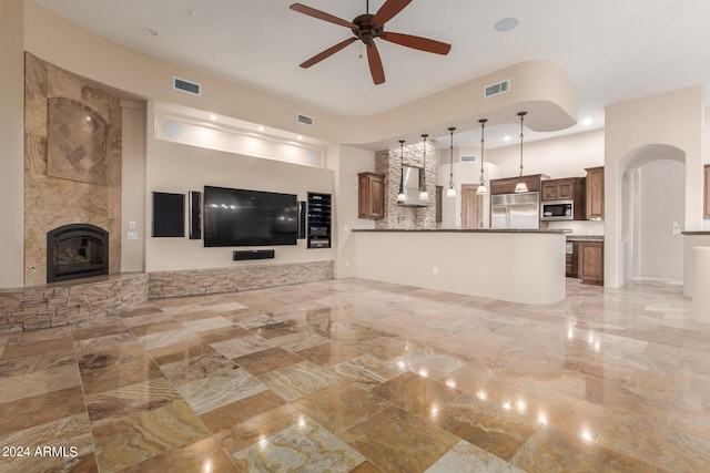 3730 E Cloud Rd, Cave Creek, AZ 85331 - unfurnished living room with marble finish floor, visible vents, a tiled fireplace, and a ceiling fan