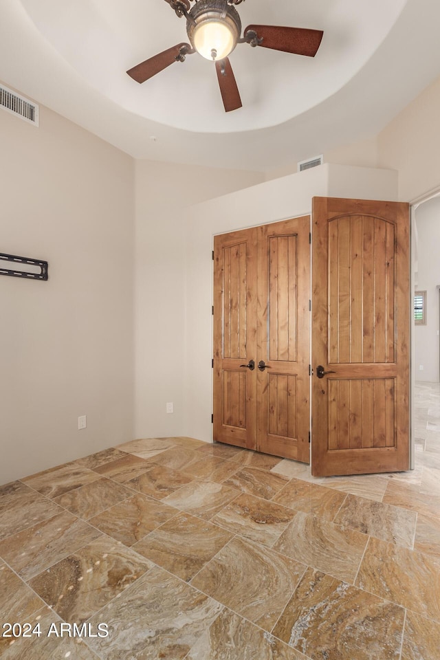 3730 E Cloud Rd, Cave Creek, AZ 85331 - unfurnished bedroom with stone finish flooring, ceiling fan, and visible vents