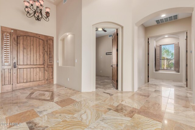 3730 E Cloud Rd, Cave Creek, AZ 85331 - entrance foyer with arched walkways, marble finish floor, visible vents, and ceiling fan with notable chandelier
