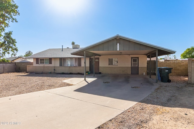 ranch-style home featuring a carport