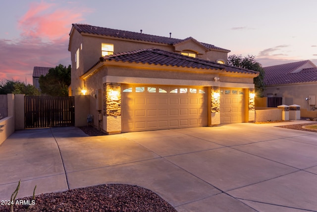 mediterranean / spanish house featuring a garage