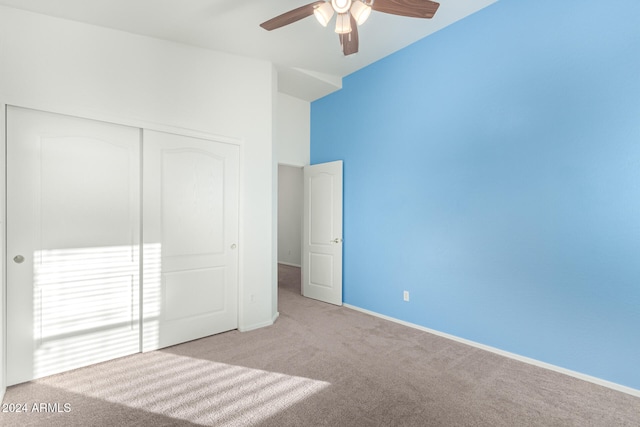 unfurnished bedroom with a closet, light carpet, and ceiling fan