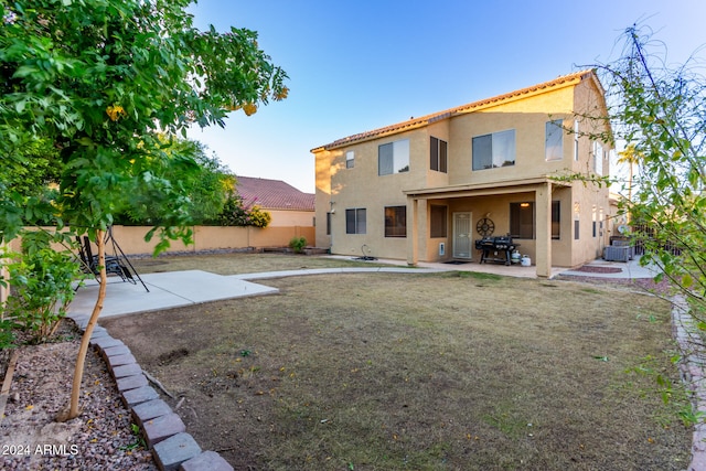 back of house with central AC and a patio