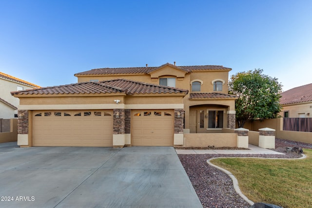 mediterranean / spanish-style home featuring a garage and a front yard