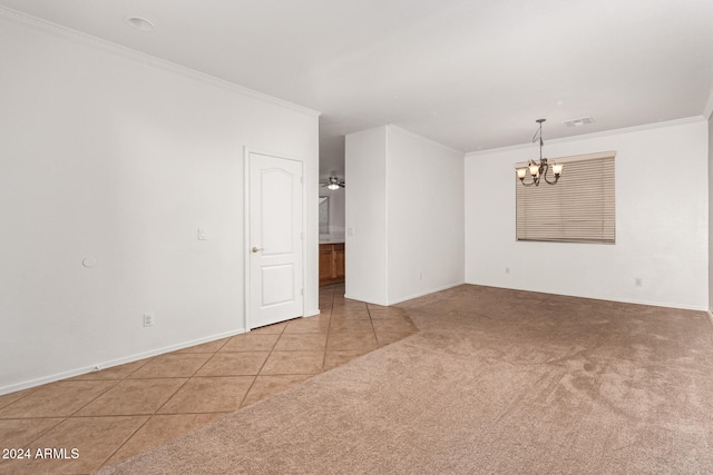 empty room with light carpet, an inviting chandelier, and crown molding