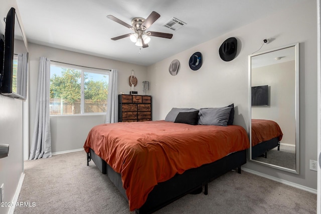 bedroom featuring a ceiling fan, light colored carpet, visible vents, and baseboards