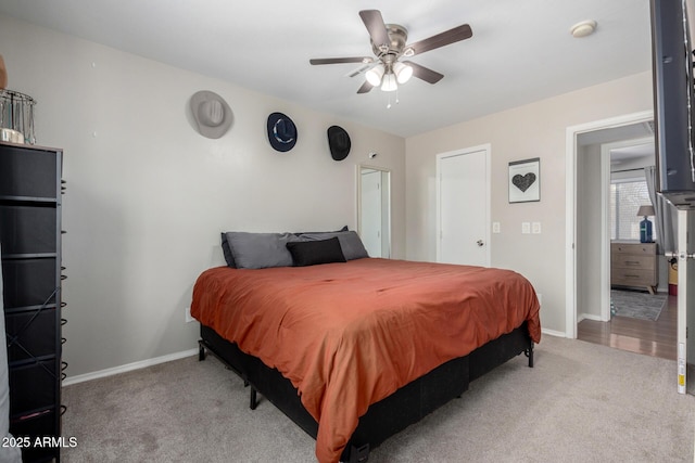 bedroom with carpet floors, baseboards, and a ceiling fan