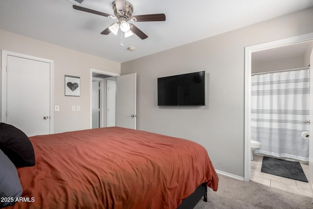 bedroom featuring light tile patterned floors, baseboards, a ceiling fan, connected bathroom, and light colored carpet