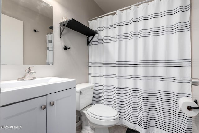 bathroom featuring toilet and vanity