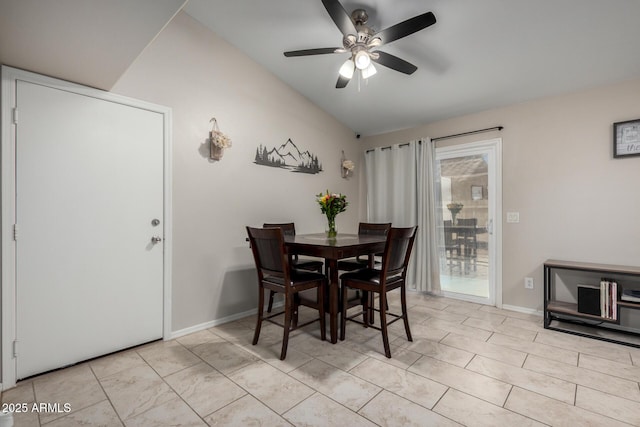 dining area with light tile patterned flooring, a ceiling fan, and baseboards