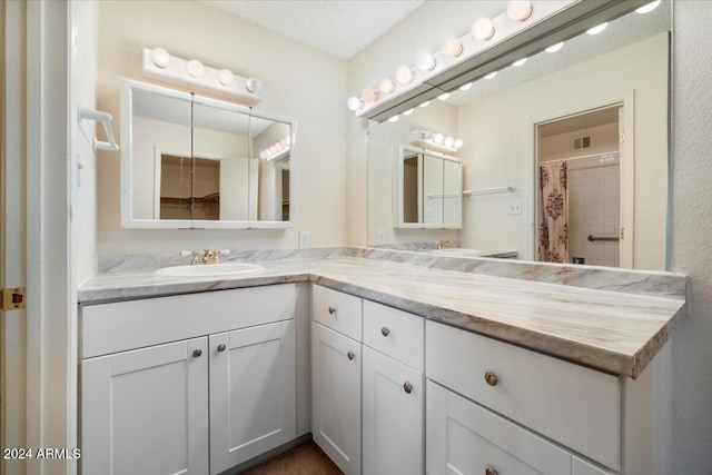 bathroom with vanity and a textured ceiling