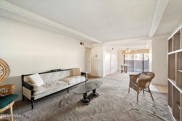 living room featuring light carpet, a textured ceiling, beam ceiling, and ceiling fan