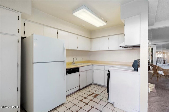 kitchen featuring sink, white cabinets, light carpet, and white appliances