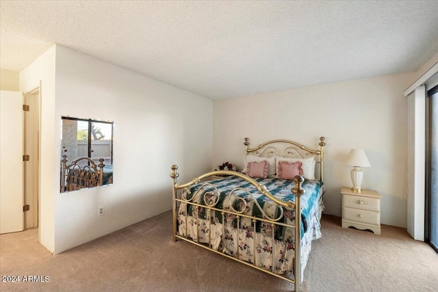 bedroom featuring carpet and a textured ceiling