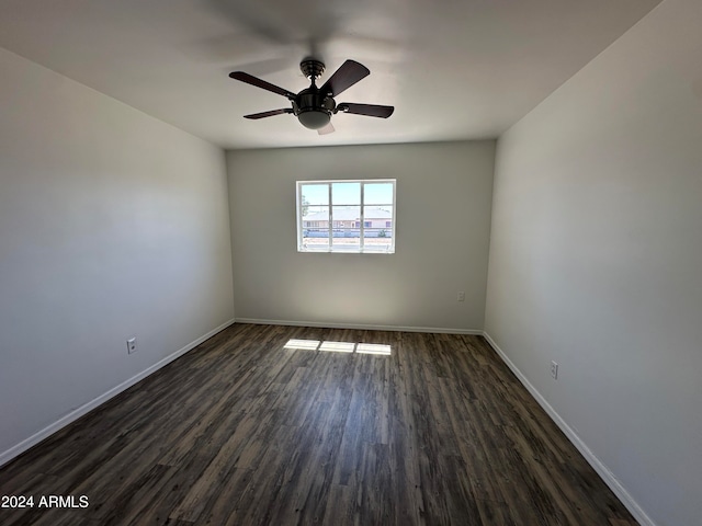 spare room featuring dark hardwood / wood-style floors and ceiling fan