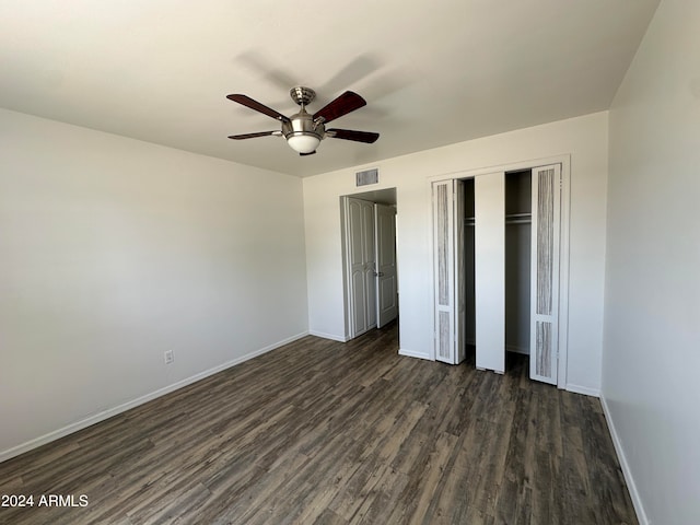 unfurnished bedroom with ceiling fan and dark hardwood / wood-style floors