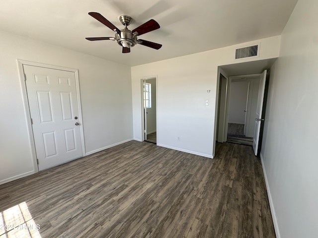 empty room featuring ceiling fan and dark hardwood / wood-style floors