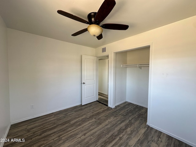 unfurnished bedroom with dark hardwood / wood-style floors, ceiling fan, and a closet