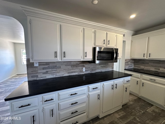 kitchen featuring white cabinets and dark hardwood / wood-style flooring