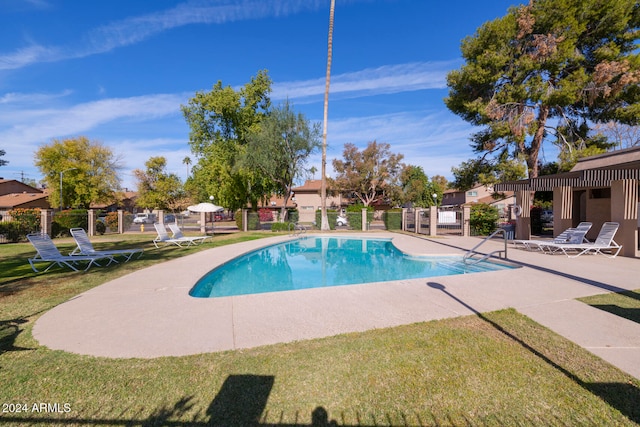 view of pool with a lawn and a patio area