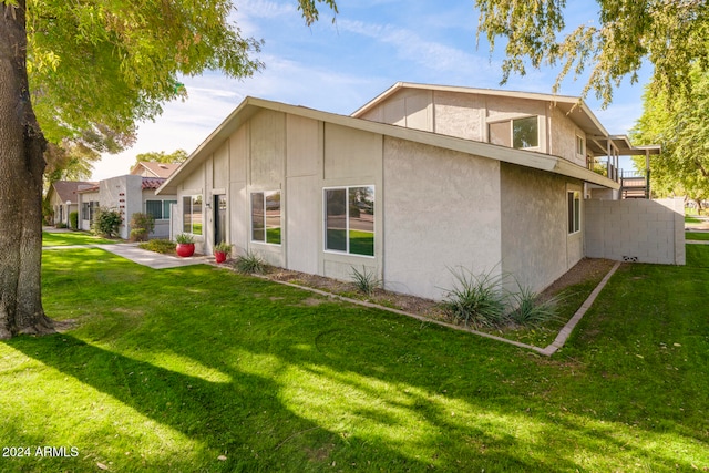 view of side of property with a lawn