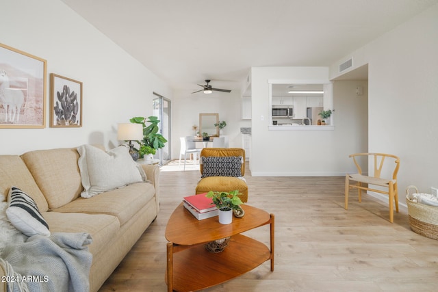 living room with ceiling fan and light wood-type flooring