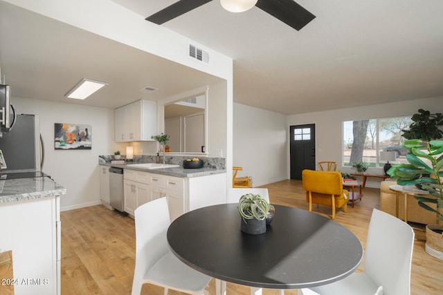 dining room featuring light wood-type flooring and sink