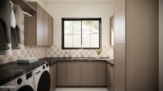 laundry area featuring cabinets, independent washer and dryer, and sink