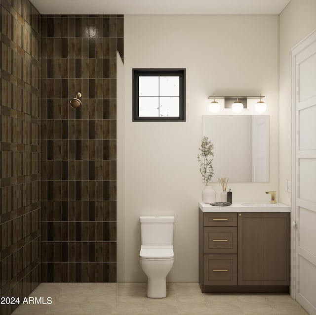 bathroom with vanity, toilet, and tiled shower