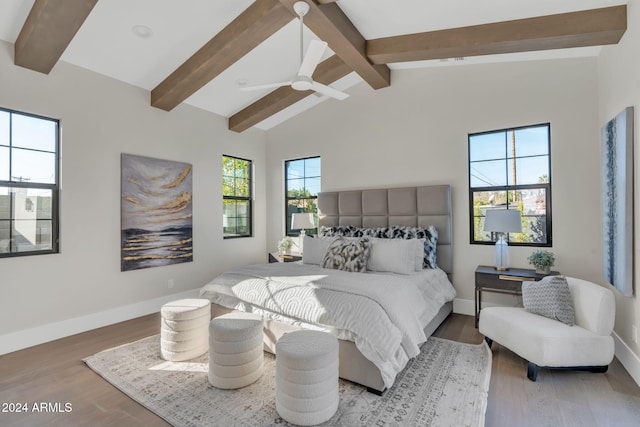 bedroom with lofted ceiling with beams, ceiling fan, and wood-type flooring