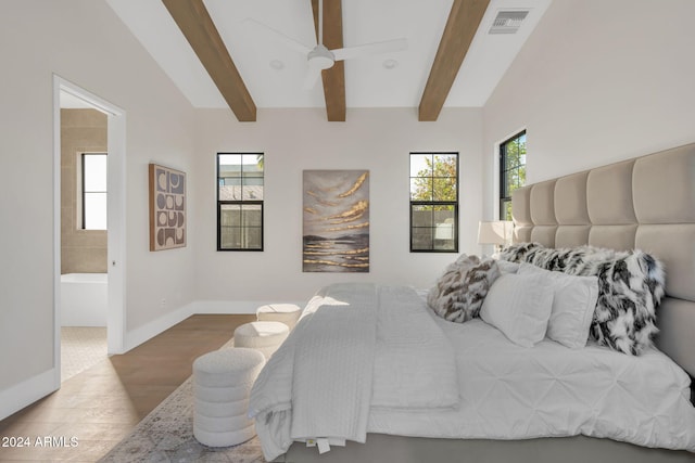 bedroom featuring ceiling fan, ensuite bath, wood-type flooring, and multiple windows