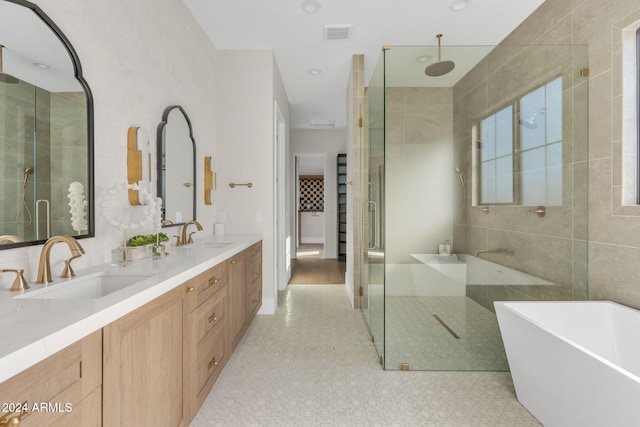 bathroom with vanity and separate shower and tub