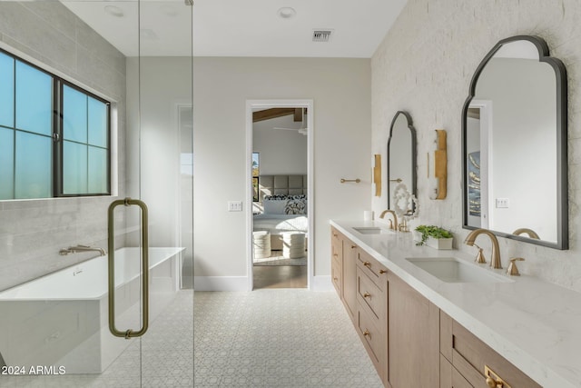 bathroom featuring vanity and a bath