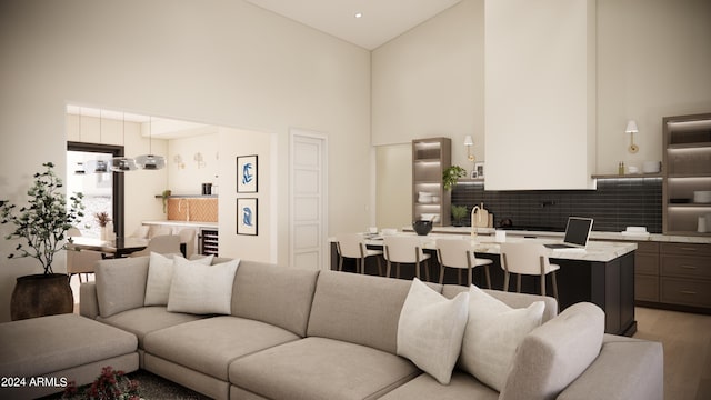 living room with high vaulted ceiling and light hardwood / wood-style flooring