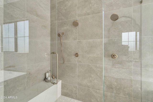 bathroom with a tile shower